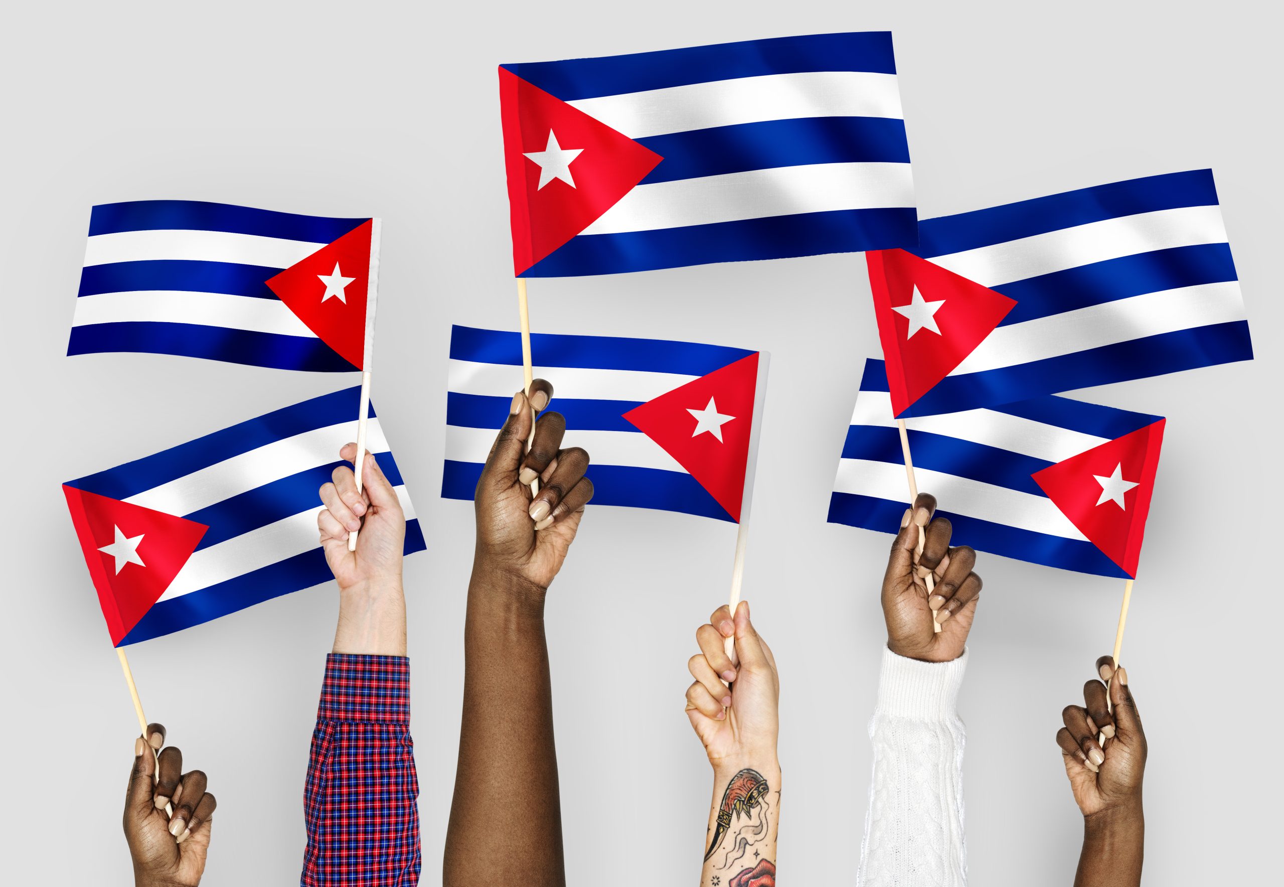 hands waving flags cuba