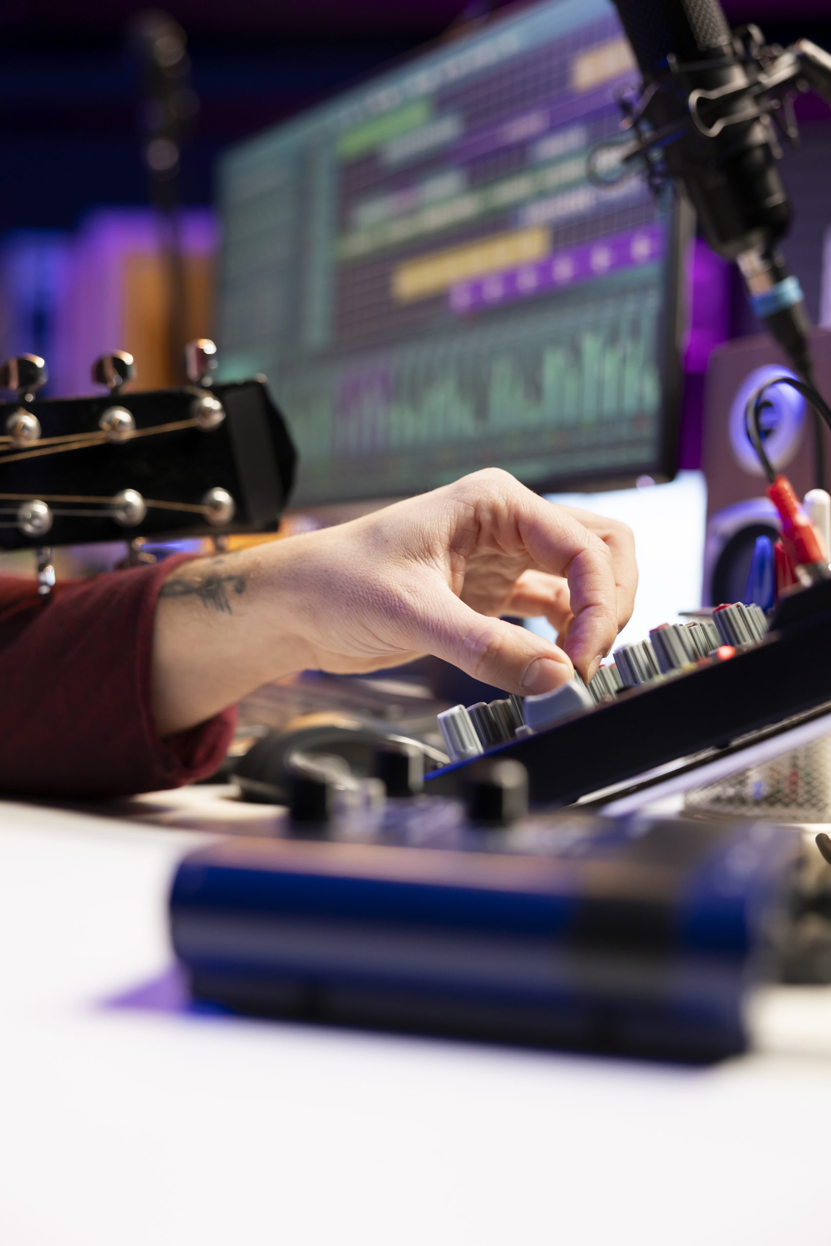 music producer twisting pre knobs mixing console edit audio recordings